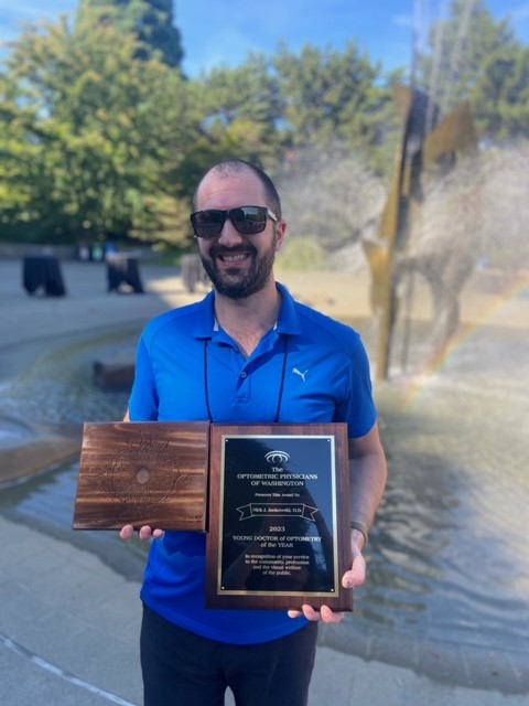 Dr Nick with his Young OD of the Year award as well as an award for his efforts specifically with legislation in OPW at Seattle University after the award ceremony