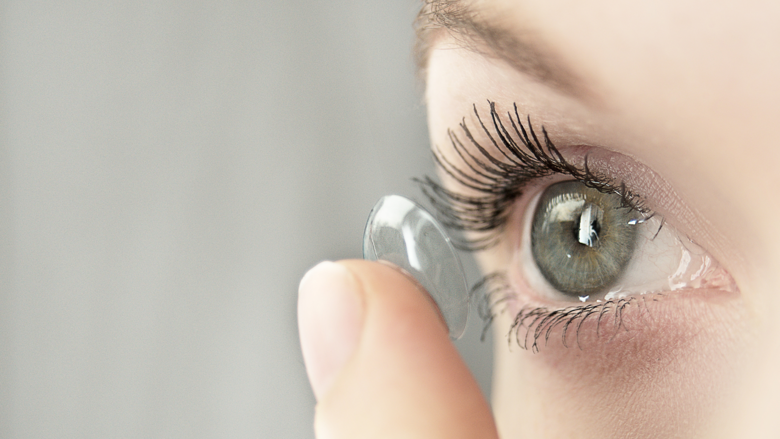 woman putting in contact lenses